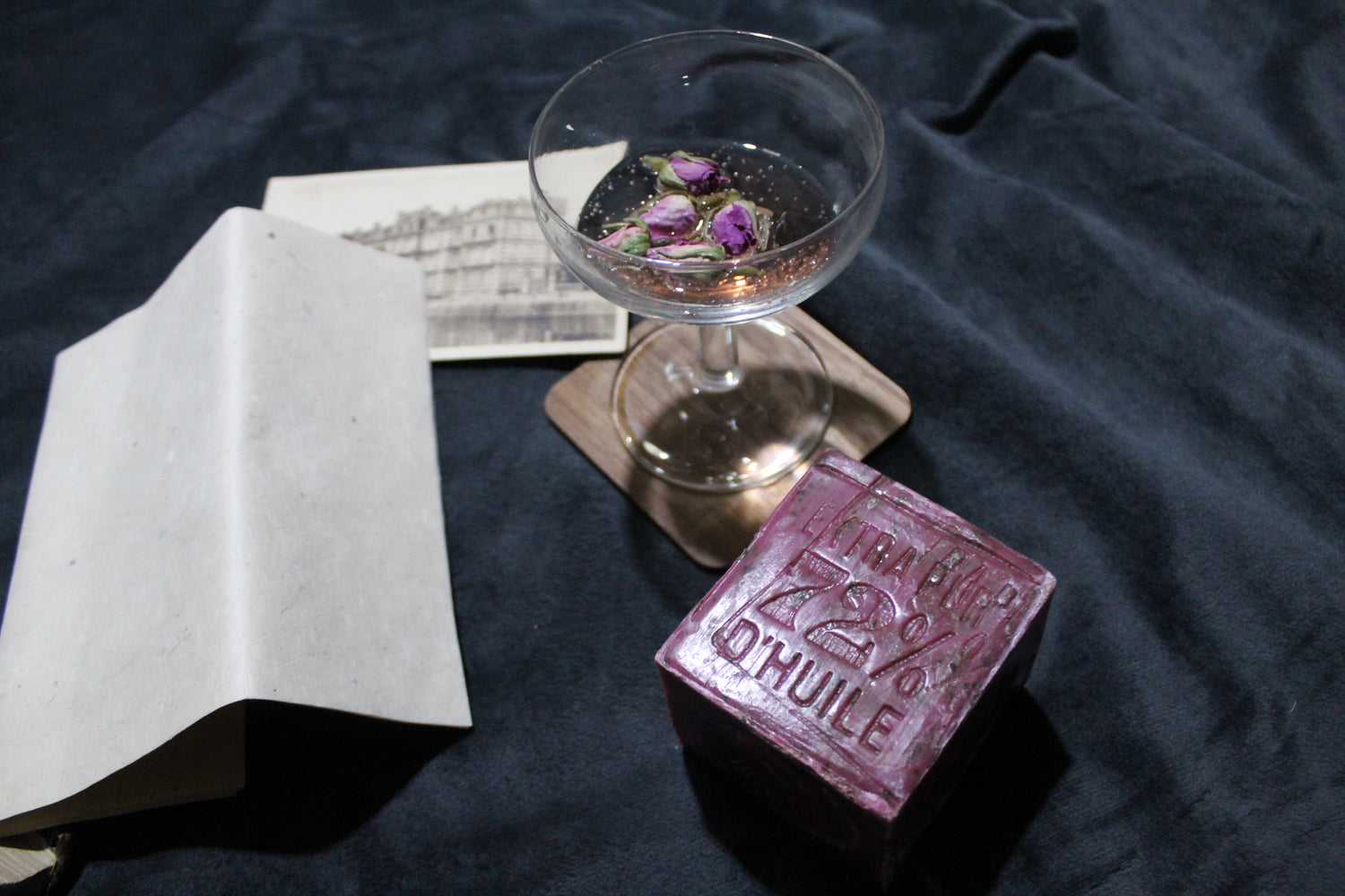 Champagne glass with garnishes, postcard, Marseille soap and letter