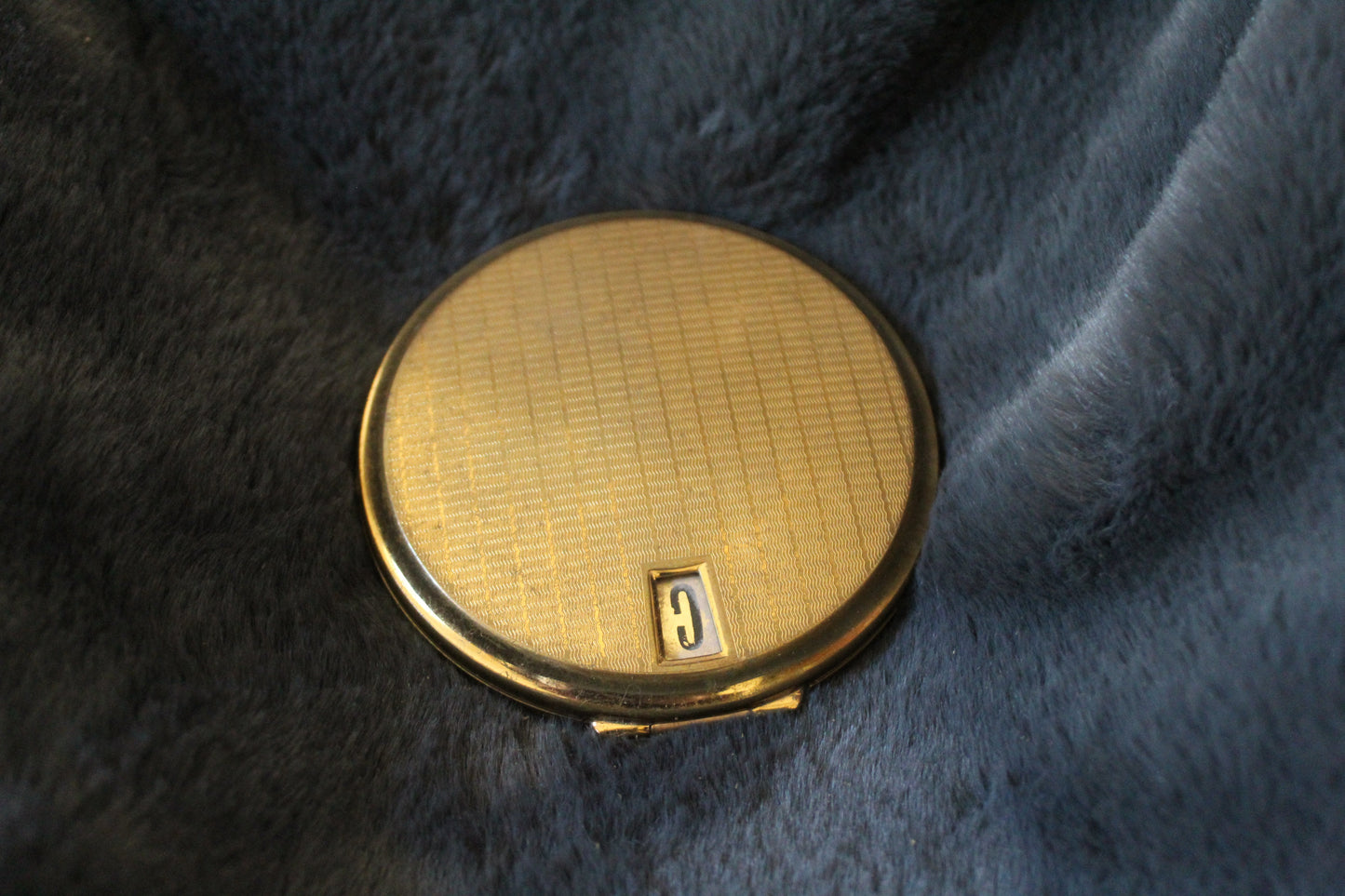 Round, gold Stratton compact