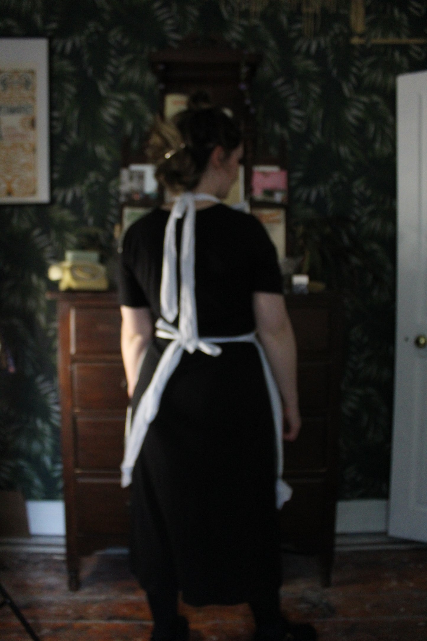 White frilly apron with floral panels