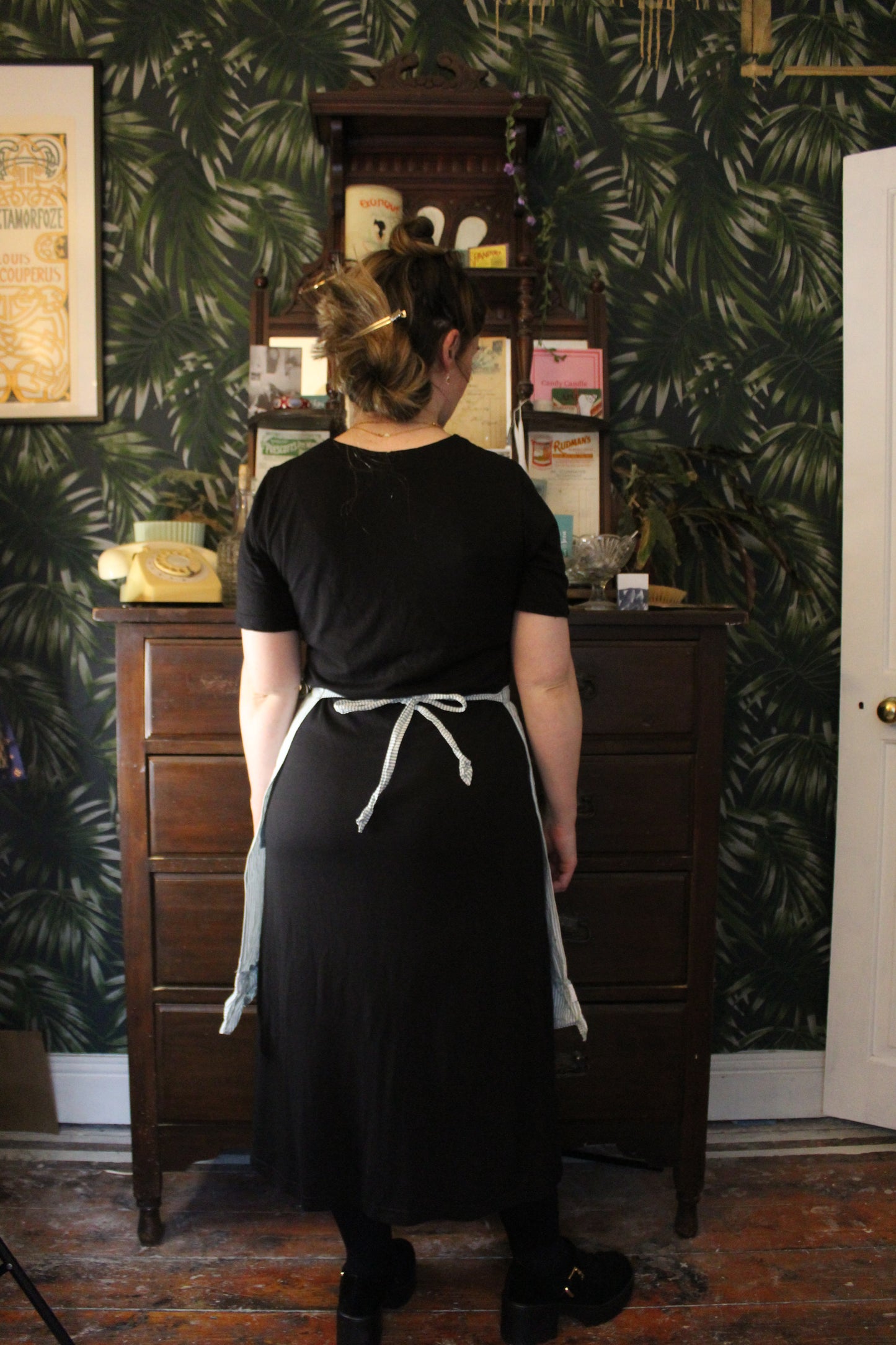 Green and white striped half apron with white trim