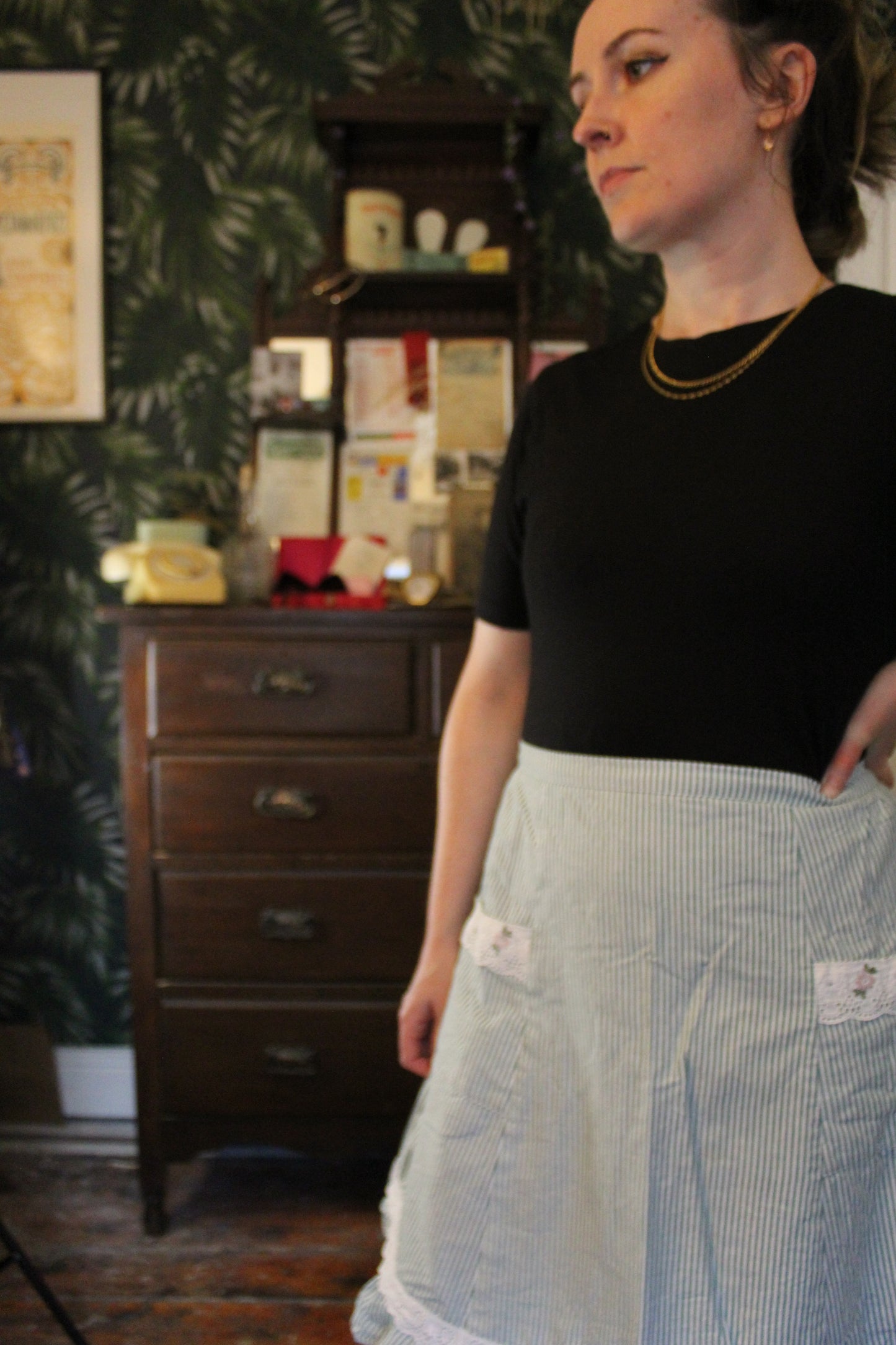 Green and white striped half apron with white trim