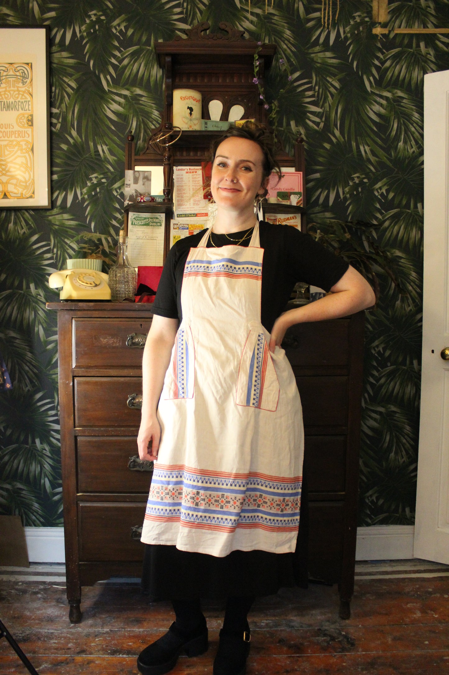 Cream canvas apron with blue and red embroidered details