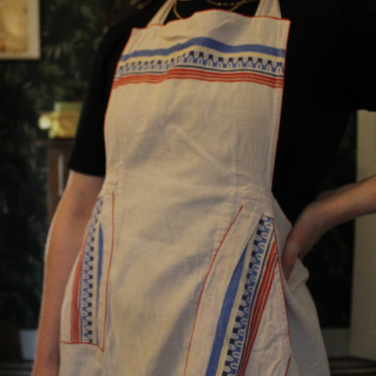 Cream canvas apron with blue and red embroidered details