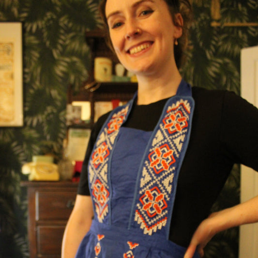 Cobalt blue apron with red and white embroidery