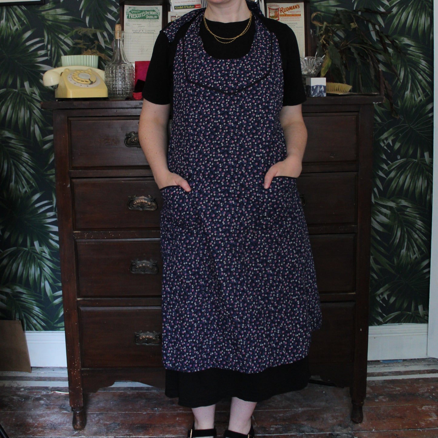 Navy apron with pink and white floral print