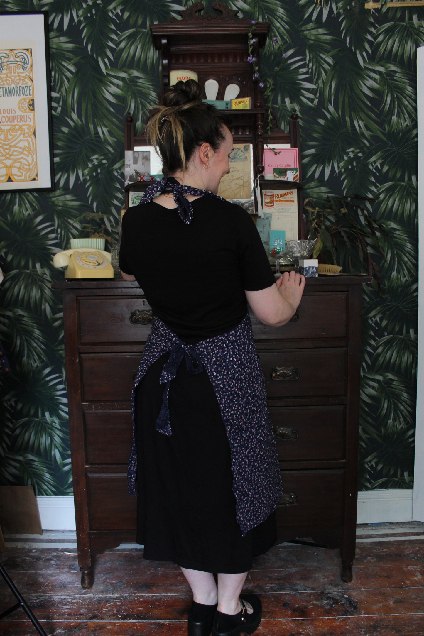 Navy apron with pink and white floral print