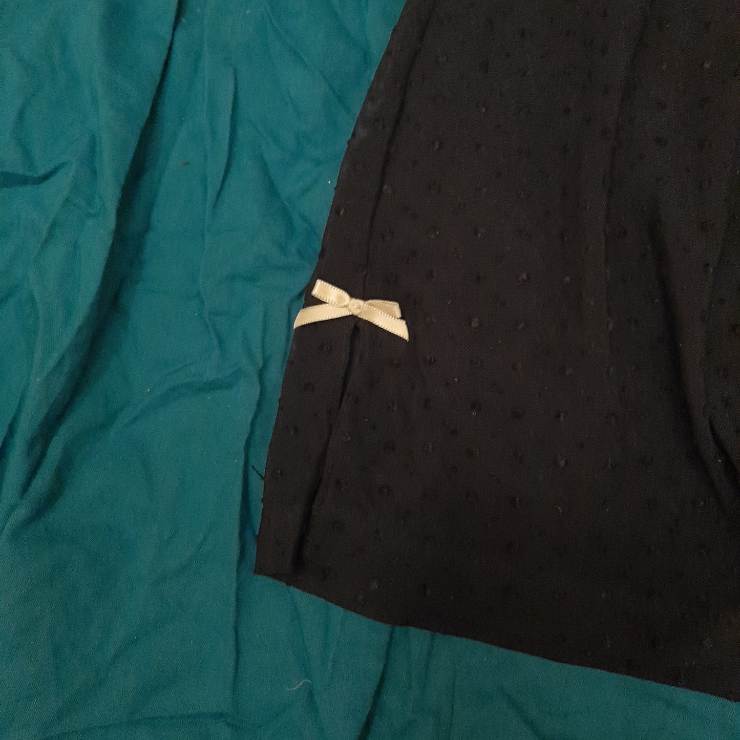 Black slip with dappled pattern and pink ribbon