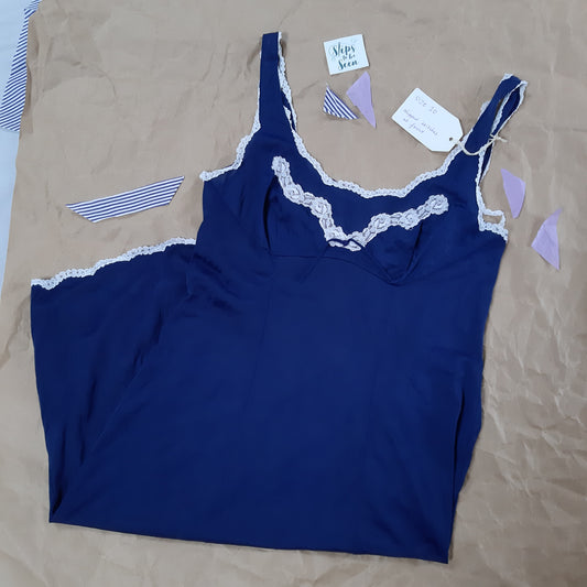 Deep blue slip with white trim and bow detail