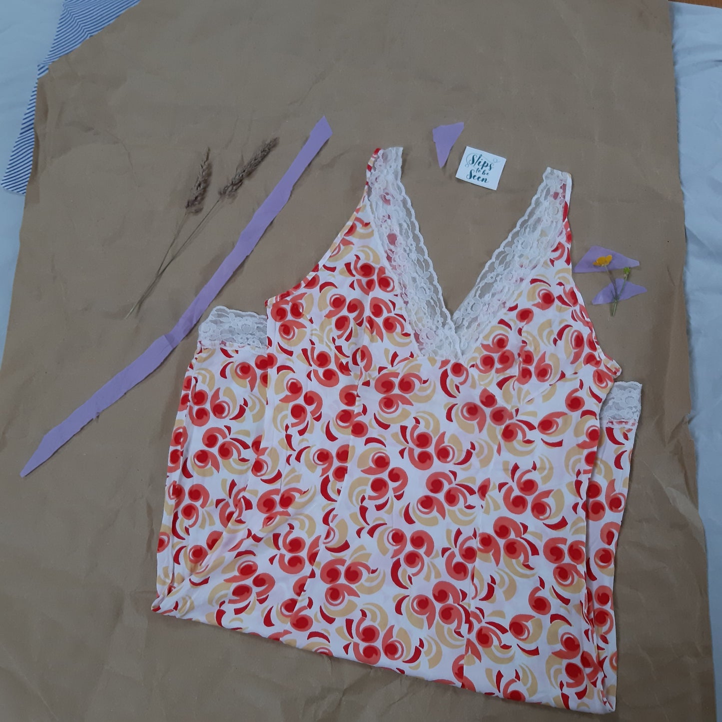 Red and orange pattern slip with white lace trim