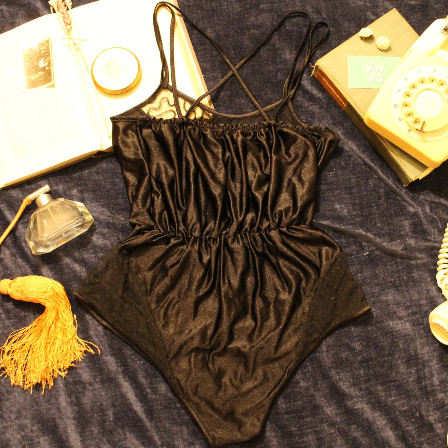 Sleek black bodysuit with intricate lace detail