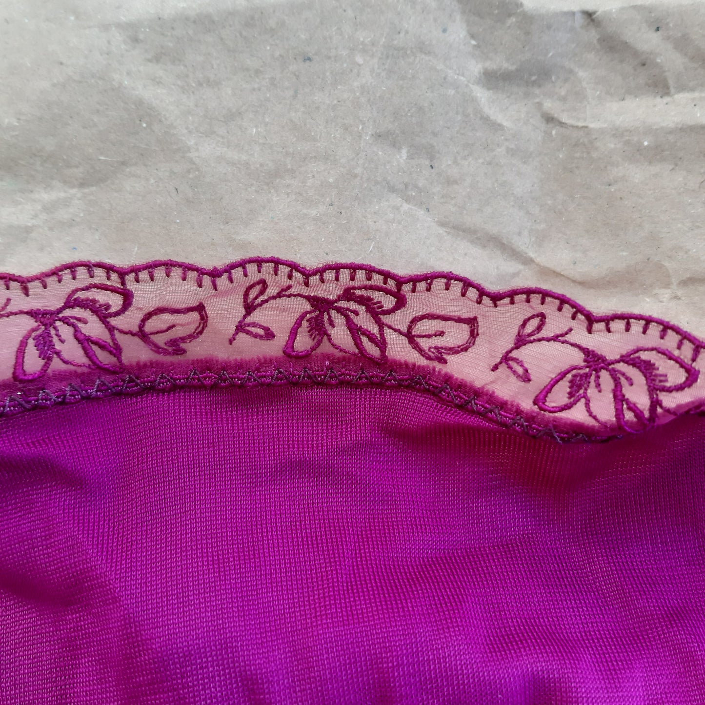 Fuschia slip with floral panels and lettuce edged trim