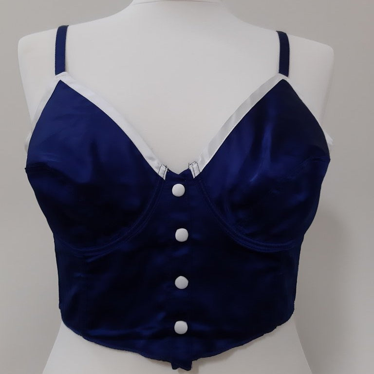 The image shows the front of an 8 Huit blue corset on a mannequin.