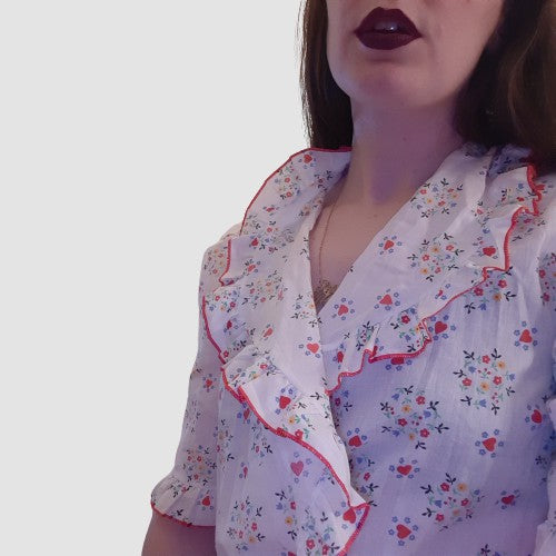 White robe with red heart and flower design