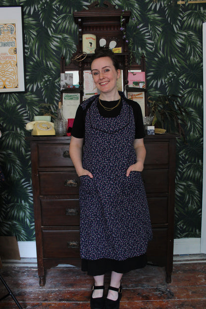 Navy apron with pink and white floral print