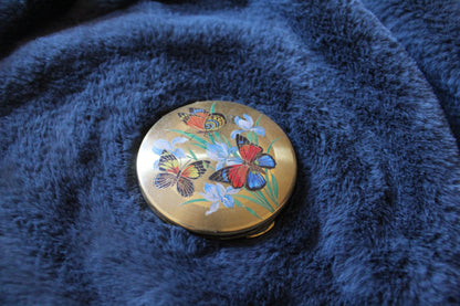 Vintage compact with butterfly illustration