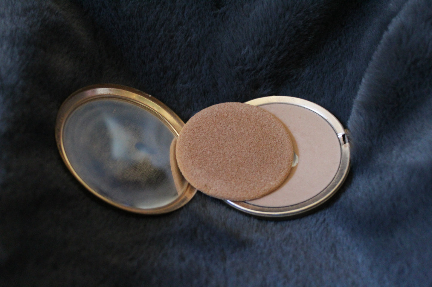 Round gold compact with floral details